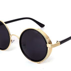 Montura dorada y lentes grises.
